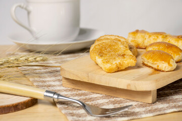 Crispy toast bread with sugar topped on wooden board.
