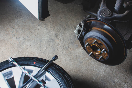 Disc brakes and calipers original system of car and wheels were uninstalled for maintenance.