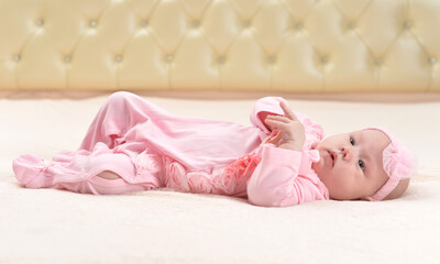 Fototapeta na wymiar Portrait of cute little baby girl on bed