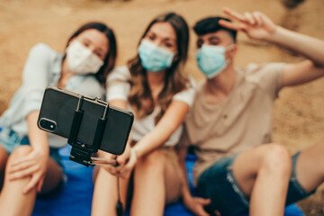 Masked pandemic friends taking a photo.