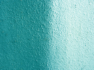Two-color turquoise-blue wall with a slightly rough texture, divided into two equal parts