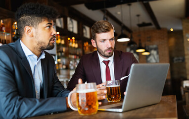 Confident business men talking and working together in a restaurant