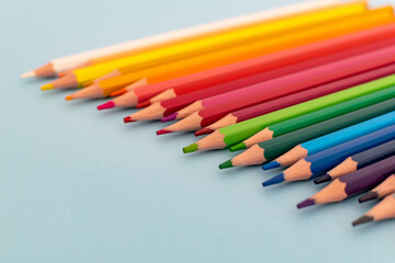 a selection of colourful sharpened pencils lined up on a table