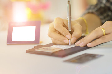 A woman's hand is signing a slip Pay credit card