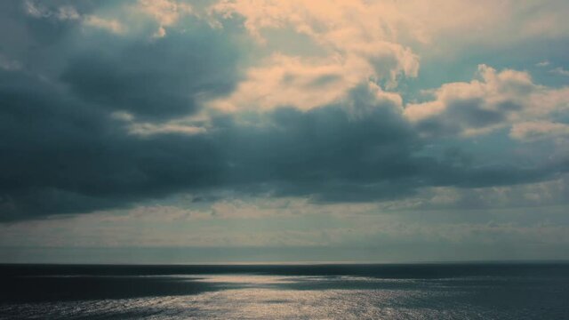 Timelapse - Fast moving dramatic cloud formations changing over the Mediterranean sea. Concept for changing weather, negative to positive, cloudy to sunny, getting better, healing, dark to light, reha