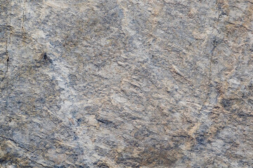 Mountain stone. Macro photo. Rough texture of mountain wild stone. Rough surface of an ancient mountain. Grunge texture. Laminated surface. Abstract grunge background. Marble. Granite. 