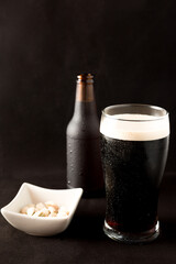 Fototapeta na wymiar beer bottle on a black background