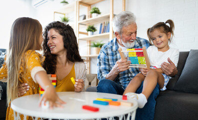 Happy family having fun time at home. Grandparent playing with children