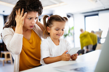 Fototapeta premium People, children, technology and addiction concept. Little girl with smartphones