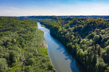 Fototapeta na wymiar Aerial Photo of the Isar river comming from the Alps direction Munich. Danube water flowing through forest in spring.