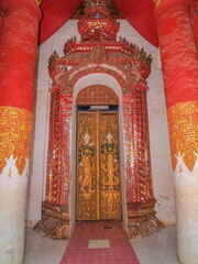 View of ancient door with angel line art in buddhist temple, Wat Wiang Sa, Nan, northern of...