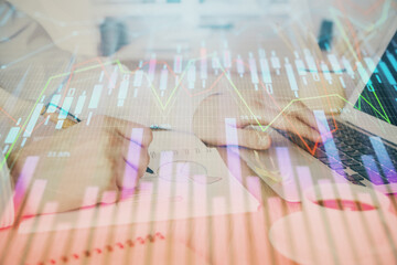Multi exposure of stock market graph with man working on laptop on background. Concept of financial analysis.
