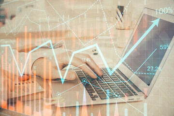 Double exposure of stock market graph with man working on laptop on background. Concept of financial analysis.