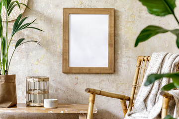 Neutral composition of living room interior with mock up picture frame, rattan armchair, a lot of...