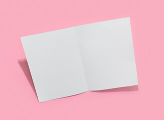Empty white paper sheet for text on pink background.