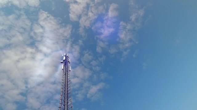 5G Cellular antenna tower and electronic radio transceiver equipment part of a cellular network under the blue sky. Radio transceiver pilon