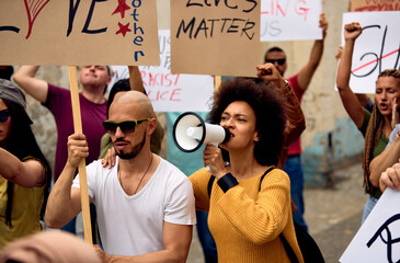 Large group of people protesting for human rights on city streets.