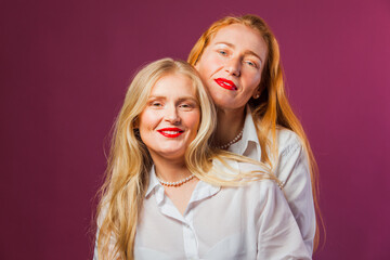 Two attractive women with bright red lipstick