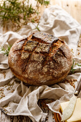 Traditional wholemeal sourdough loaf of  bread with addition rosemary herb