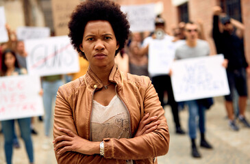African American woman with arms crossed on Black lives Matter protest.