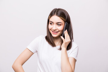 Fototapeta premium Young pretty woman in casual talking on the phone isolated white background