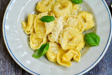 Home made vegetarian  italian  bio  egg  fresh   tortelloni pasta   for cheese garnished  with olive oil    and parmesan cheese