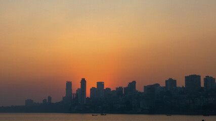Fototapeta na wymiar Skyline of Mumbai city at sunset with sea