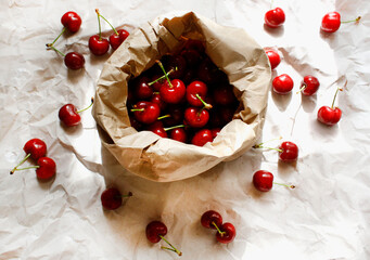 Cherries in a paper bag on a paper background