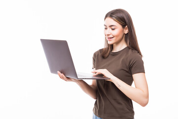 Portrait of a smiling girl holding laptop isolated on a white background and looking at camera
