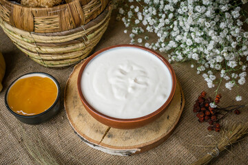 
Thick sour cream in a pot on the table