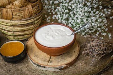 
Thick sour cream in a pot on the table