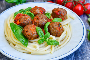Spaghetti pasta Italian home made meal. Mediterranean food concept .Spaghetti pasta meatballs with tomato sauce, basil, herbs ,parmesan cheese 