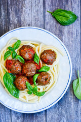 Spaghetti pasta Italian home made meal. Mediterranean food concept .Spaghetti pasta meatballs with tomato sauce, basil, herbs ,parmesan cheese 