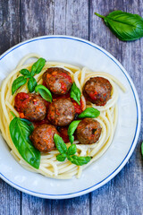 Spaghetti pasta Italian home made meal. Mediterranean food concept .Spaghetti pasta meatballs with tomato sauce, basil, herbs ,parmesan cheese 