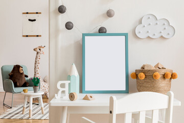 Modern and design scandinavian interior of kidroom with white desk, armachirs, mock up poster frame, natural basket, teddy bear, plush toys and cute children's accessories.