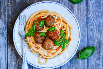 Spaghetti pasta Italian home made meal. Mediterranean food concept .Spaghetti pasta meatballs with tomato sauce, basil, herbs ,parmesan cheese 