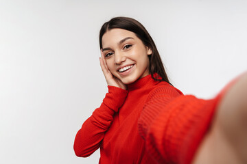 Photo of joyful caucasian woman laughing while taking selfie photo