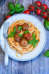 Spaghetti pasta Italian home made meal. Mediterranean food concept .Spaghetti pasta meatballs with tomato sauce, basil, herbs ,parmesan cheese 
