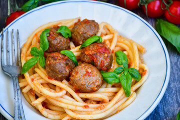 Spaghetti pasta Italian home made meal. Mediterranean food concept .Spaghetti pasta meatballs with tomato sauce, basil, herbs ,parmesan cheese 
