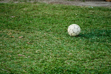 White soccer ball on the grass