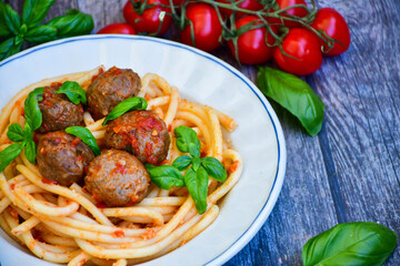 Spaghetti pasta Italian home made meal. Mediterranean food concept .Spaghetti pasta meatballs with tomato sauce, basil, herbs ,parmesan cheese 