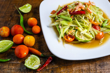 Thai food  papaya salad on a wooden table