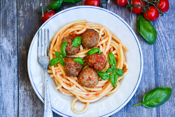 Spaghetti pasta Italian home made meal. Mediterranean food concept .Spaghetti pasta meatballs with tomato sauce, basil, herbs ,parmesan cheese 