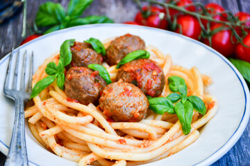 Spaghetti pasta Italian home made meal. Mediterranean food concept .Spaghetti pasta meatballs with tomato sauce, basil, herbs ,parmesan cheese 