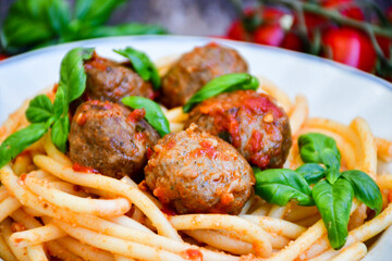 Spaghetti pasta Italian home made meal. Mediterranean food concept .Spaghetti pasta meatballs with tomato sauce, basil, herbs ,parmesan cheese 