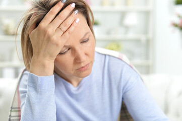 Portrait of beautiful young woman with headache