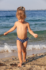 little girl runs in the shallows
