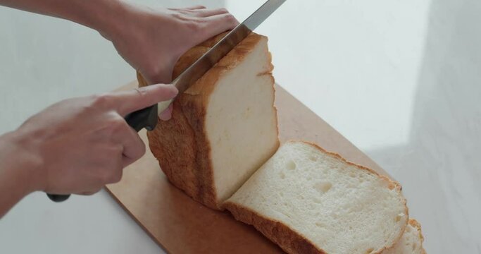 Cut a white bread with knife
