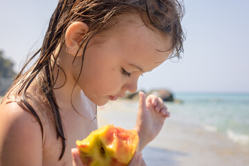 little girl eating a peach