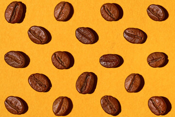 Coffee beans on a yellow background. Contrasting colors, minimalism